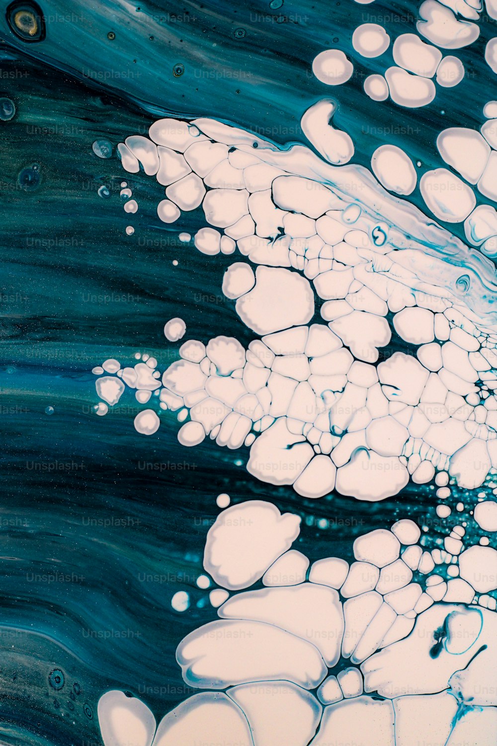 a blue and white painting with bubbles in the water