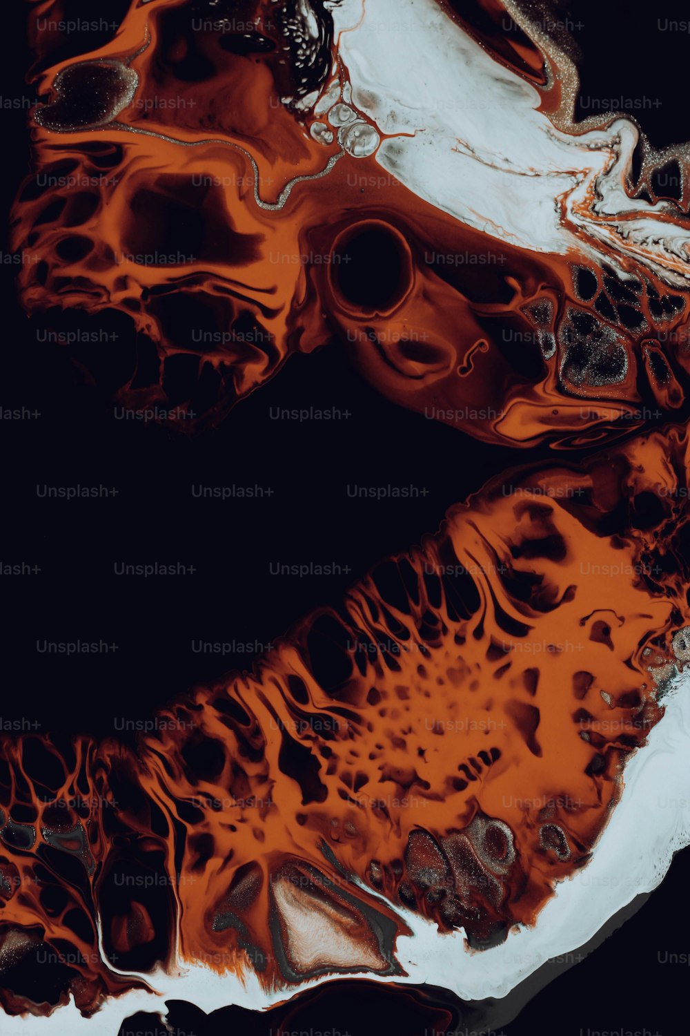 a close up of an orange and black substance