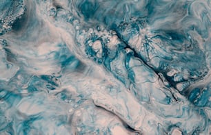 a close up of a blue and white marble