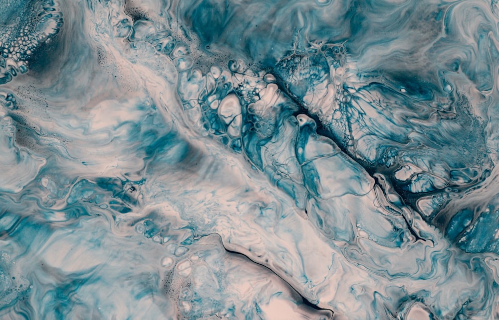 a close up of a blue and white marble