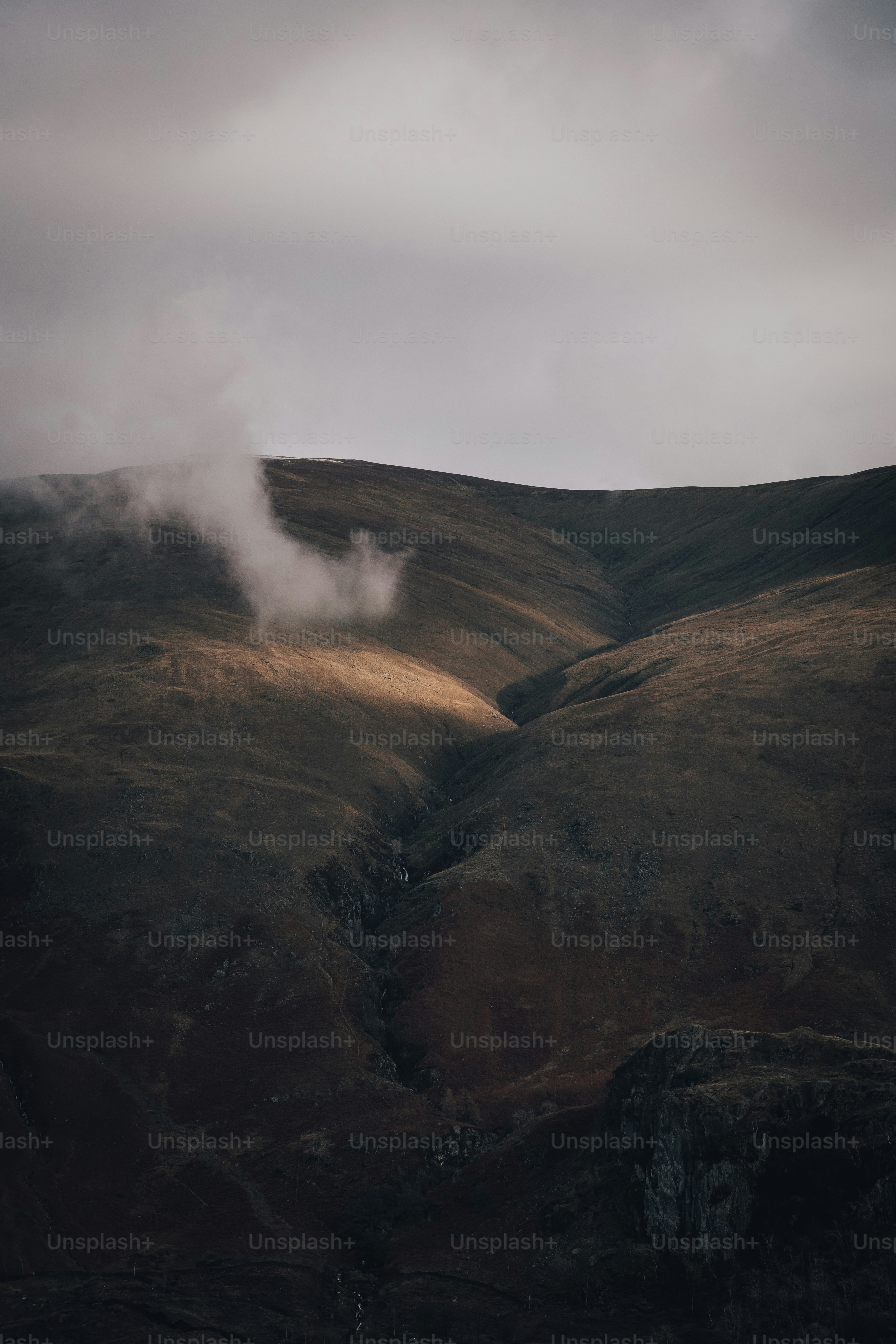 a hill with a small stream of water coming out of it