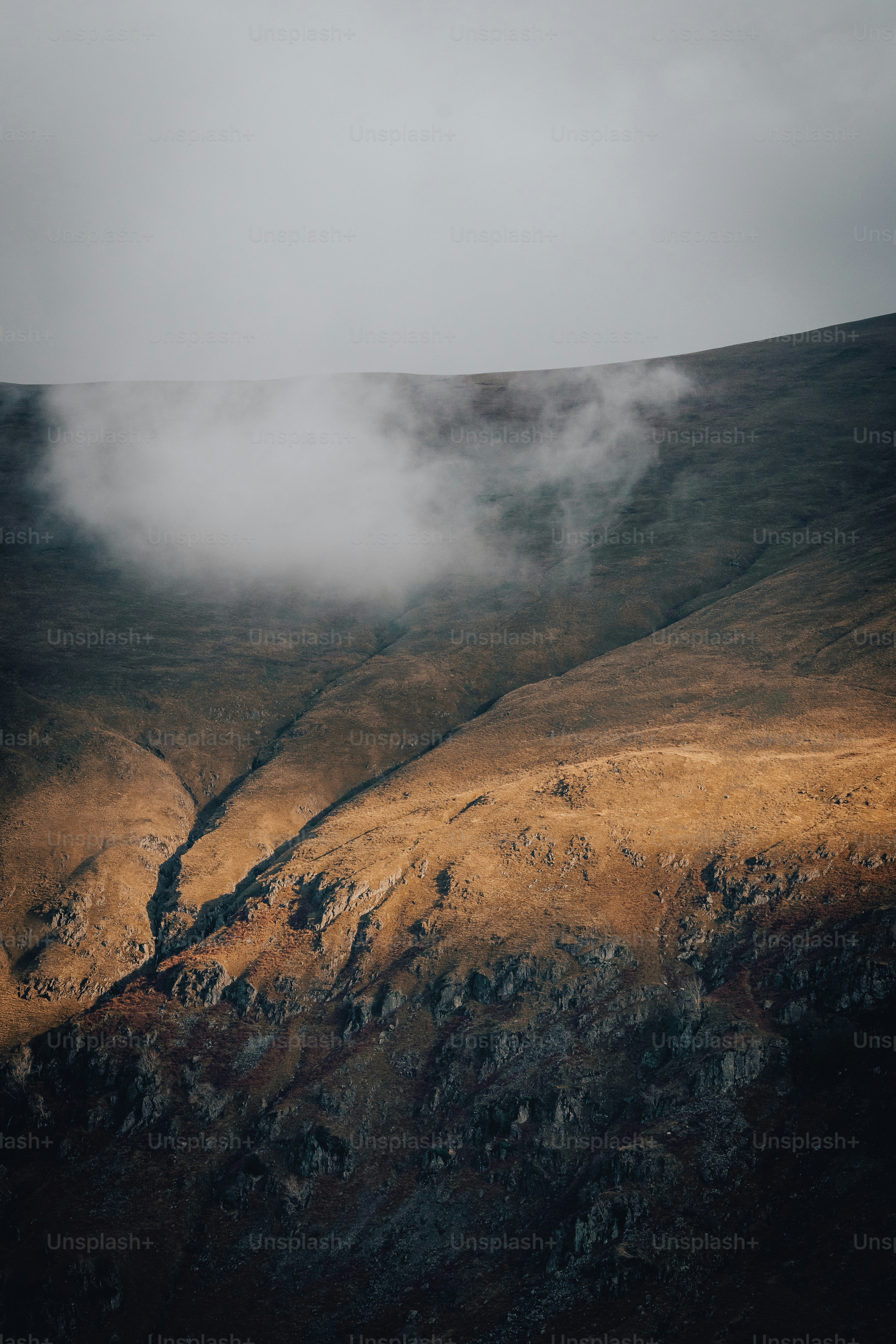 a view of a mountain with a few clouds in the sky