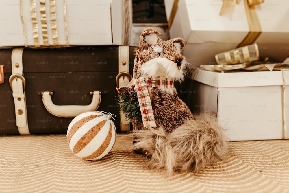 a stuffed animal sitting next to a christmas ornament