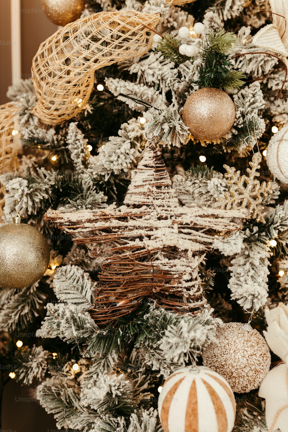 a christmas tree decorated with gold and white ornaments