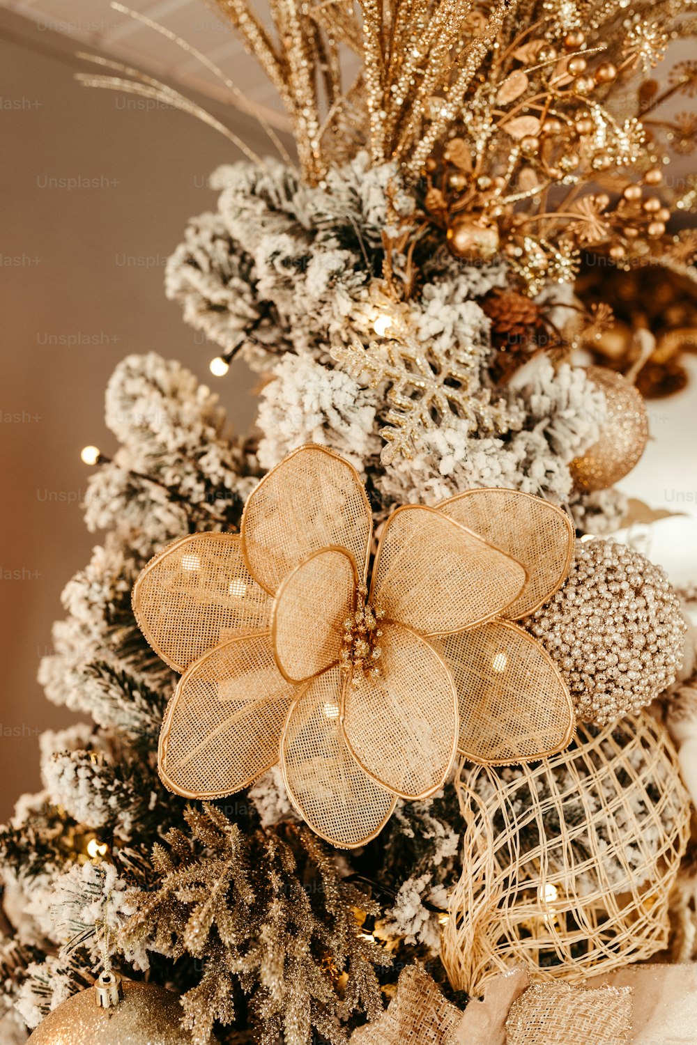 a close up of a christmas tree with gold decorations