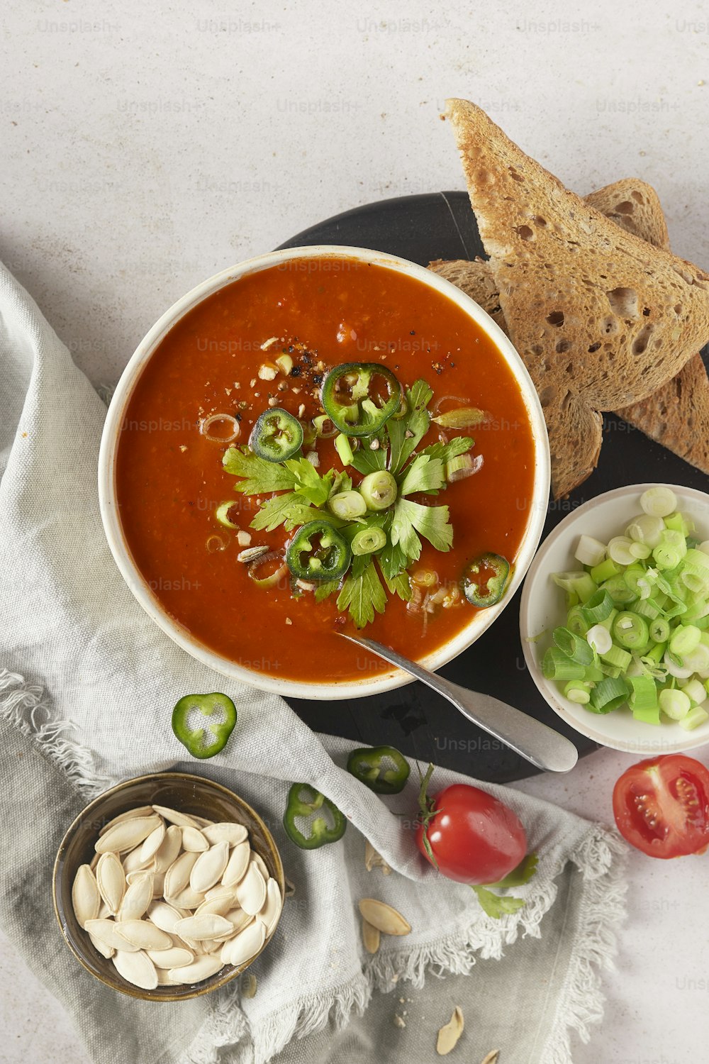 uma tigela de sopa de tomate com um lado de bolachas