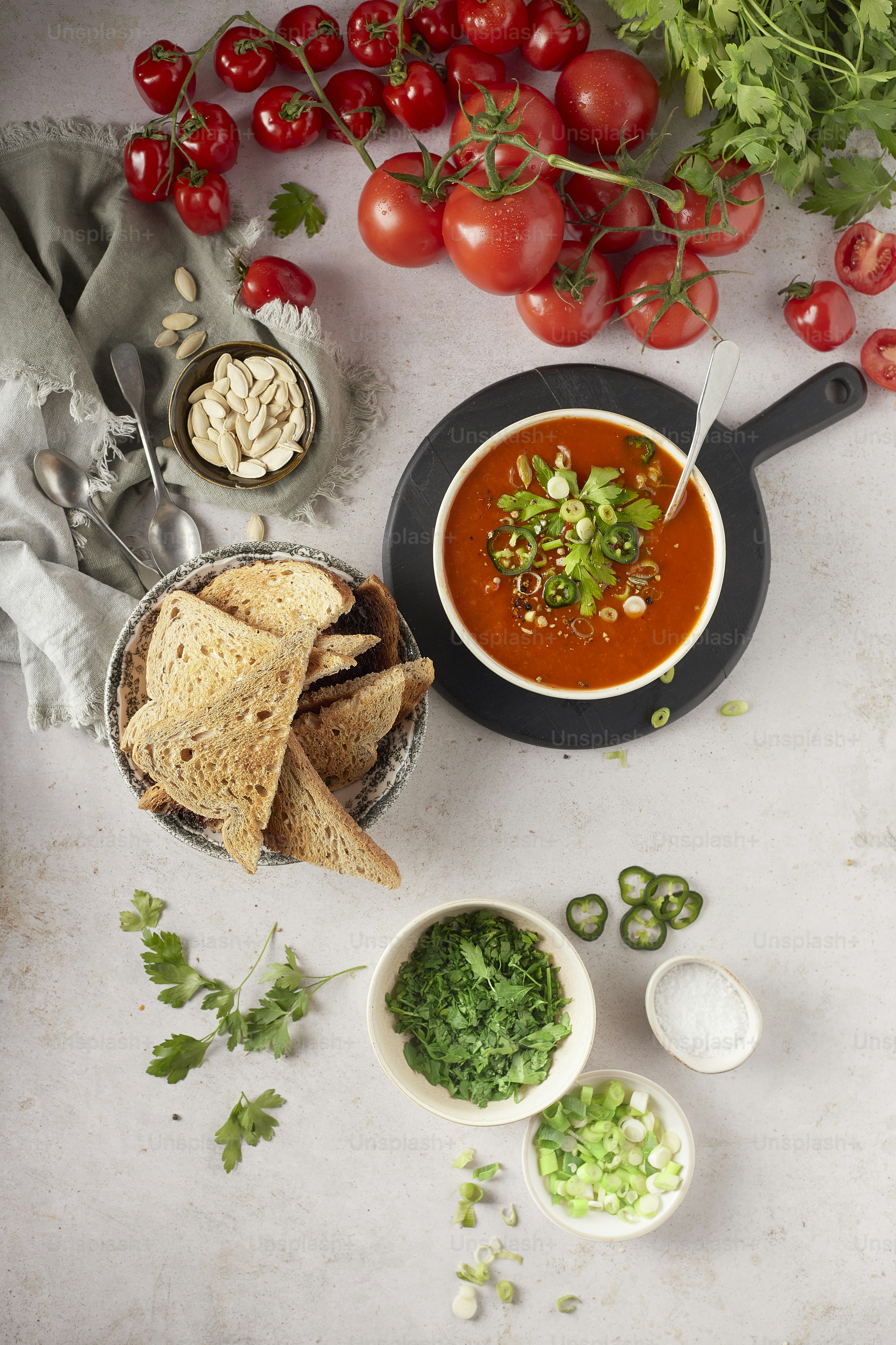a table topped with bowls of soup and bread
