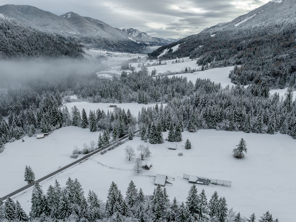 an aerial view of a snowy mountain valley