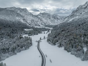 a long road in the middle of a snowy mountain