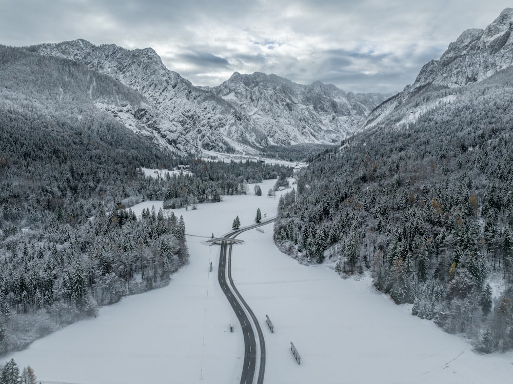 a long road in the middle of a snowy mountain