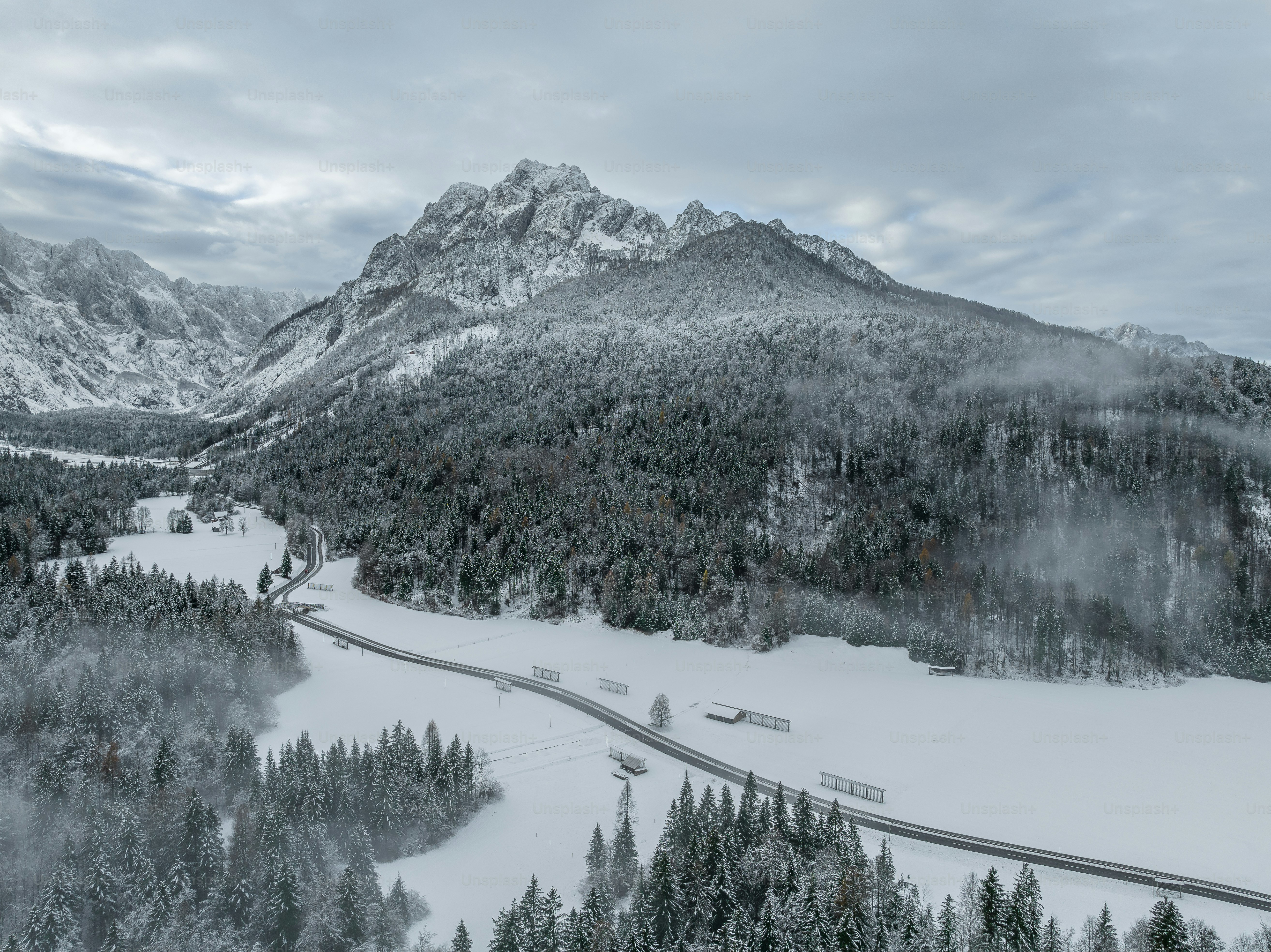 A scenic view of a snowy mountain range photo – Winter Image on Unsplash