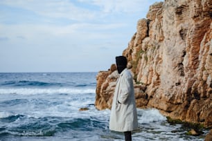 a person standing on a beach near the ocean