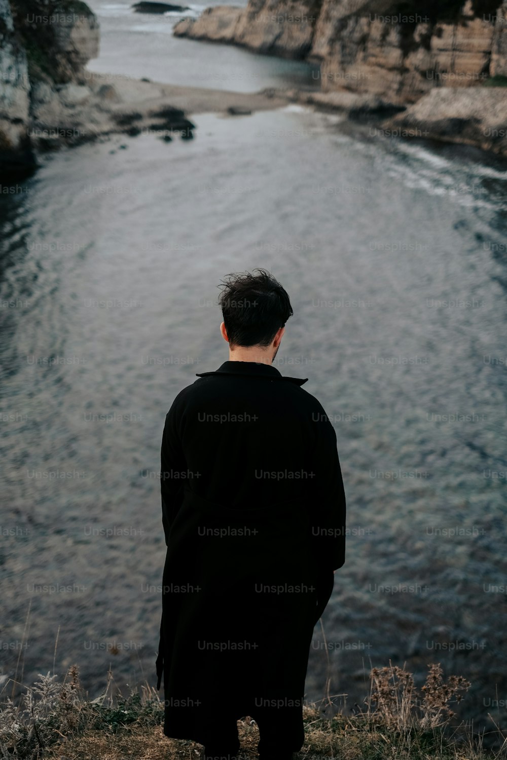 a man looking out over a body of water
