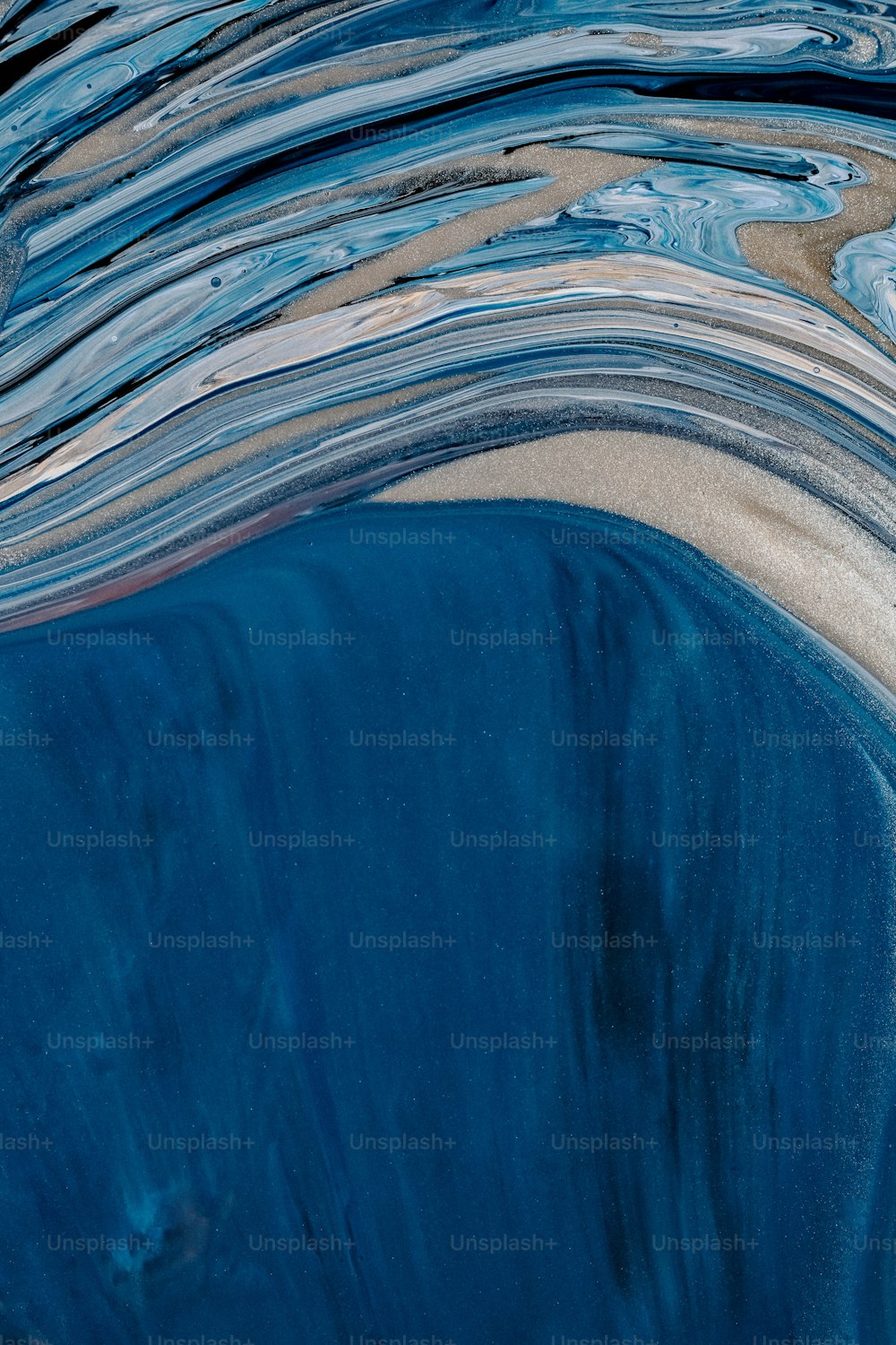 a close up of a blue water surface with waves