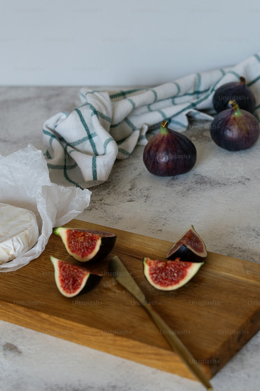 a wooden cutting board topped with sliced up figs