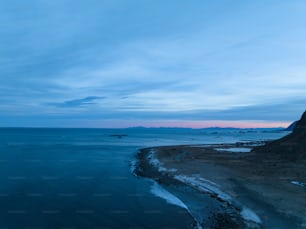 a body of water with a mountain in the background