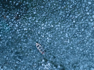 a small boat floating on top of a body of water