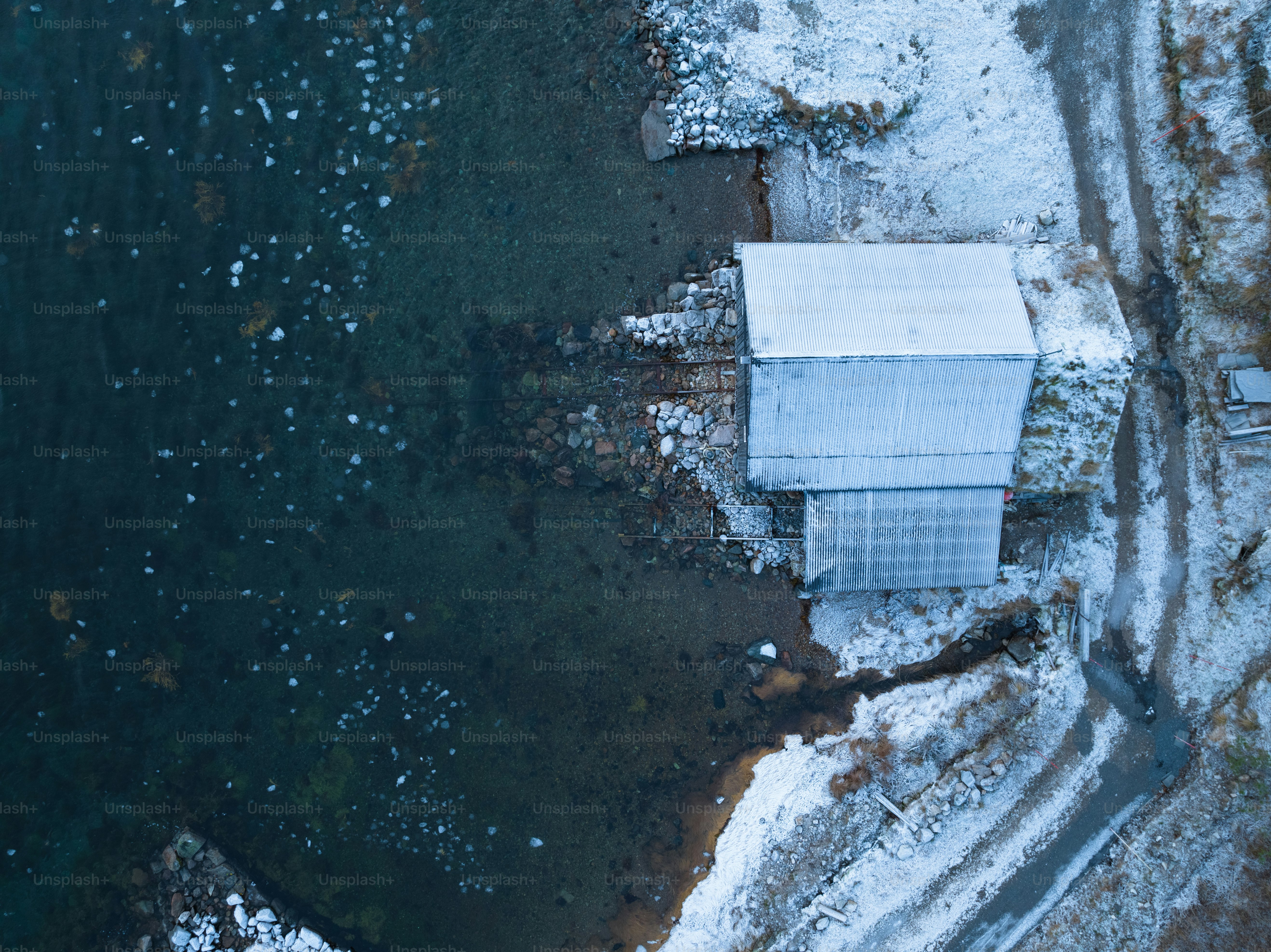 An aerial view of a white building in the snow photo – Shed Image on ...