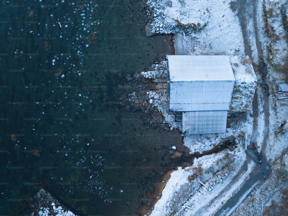 an aerial view of a white building in the snow