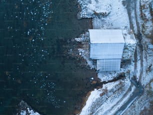an aerial view of a white building in the snow