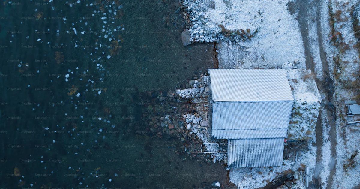 An aerial view of a white building in the snow photo – Shed Image on ...