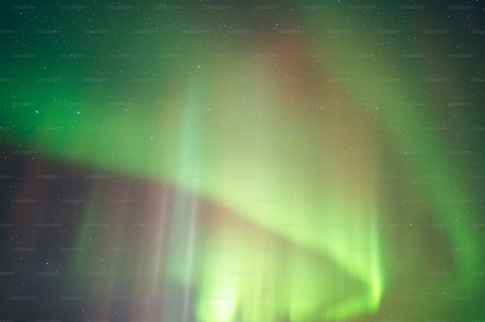 a bright green and red aurora bore in the night sky