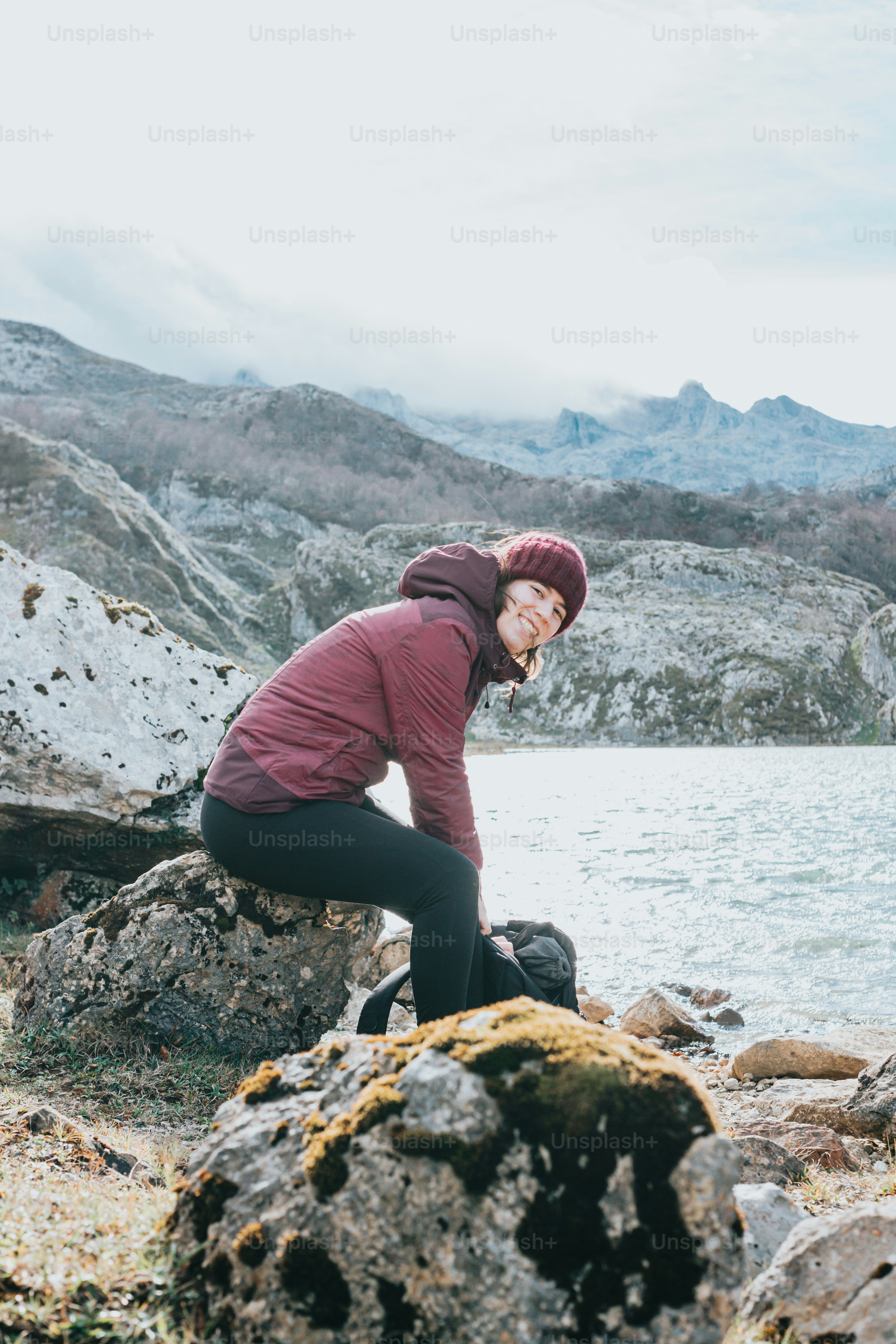 A woman standing next to a body of water photo – Outdoor gear Image on ...