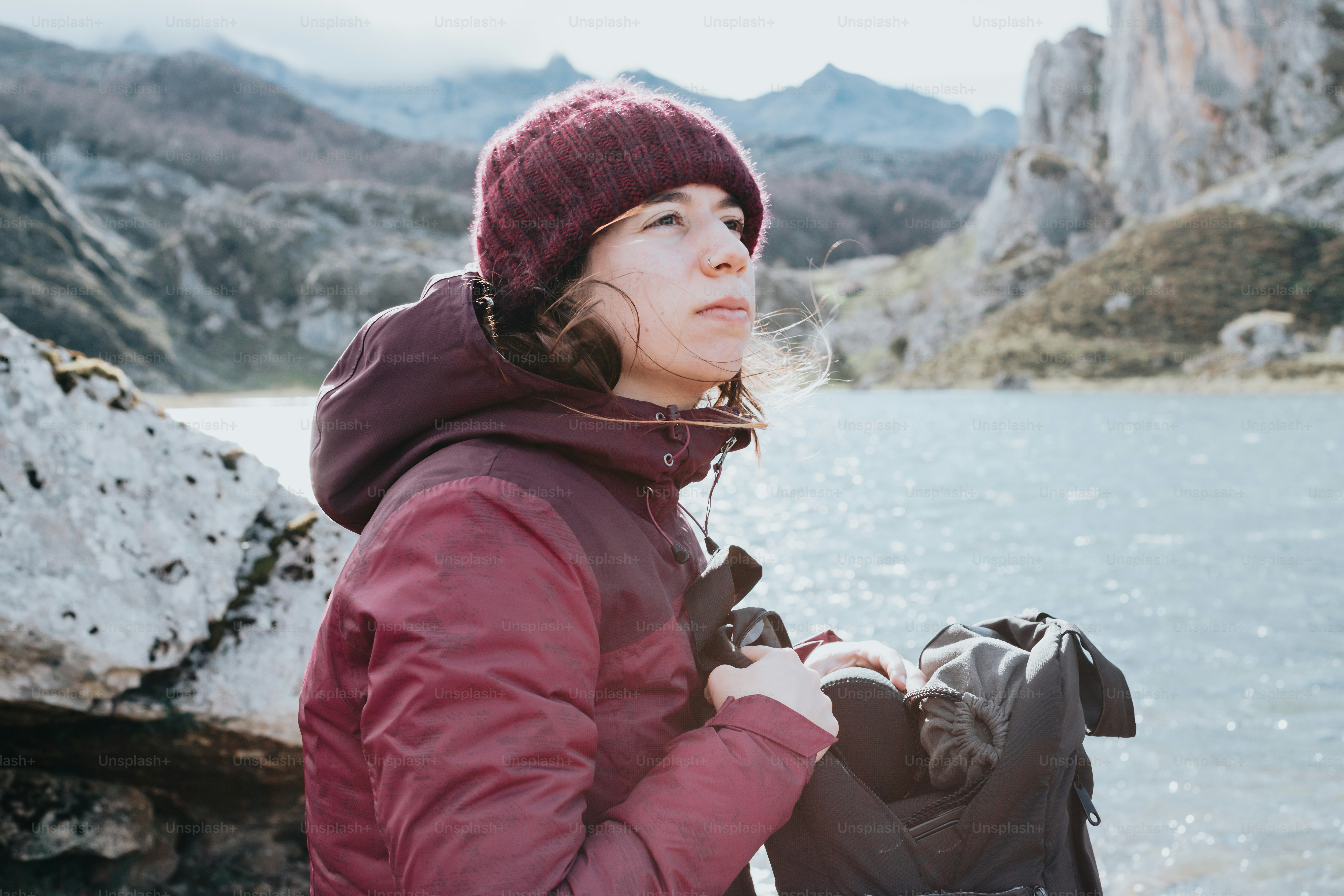 A woman standing next to a body of water photo – Outdoor gear Image on ...