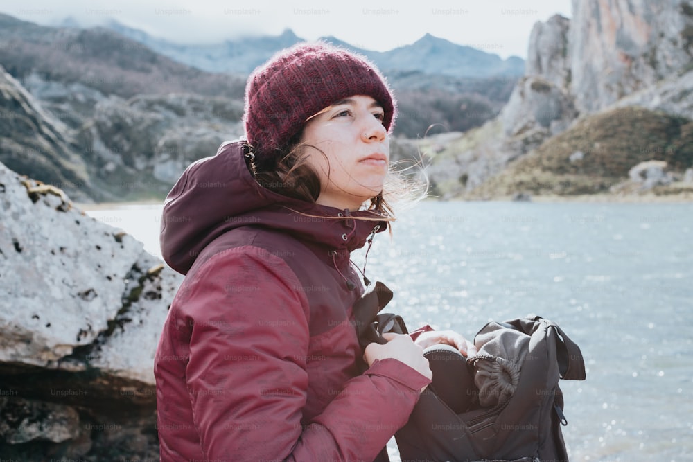 a woman standing next to a body of water