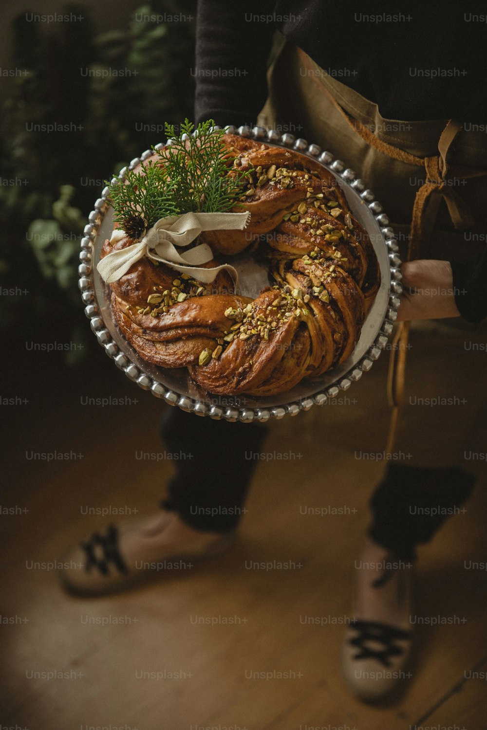 a person holding a platter of food on a wooden floor