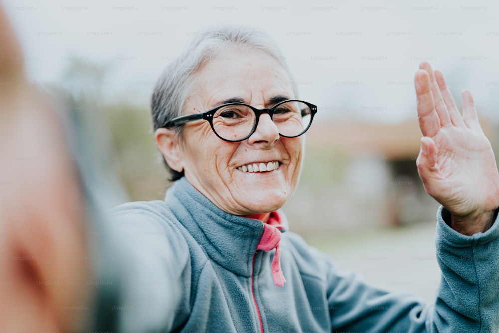 an older woman wearing glasses and smiling