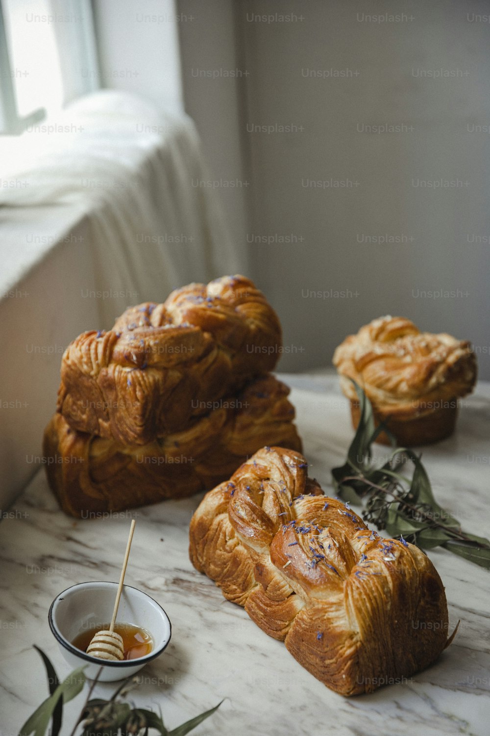 a table topped with croissants and a bowl of dipping sauce