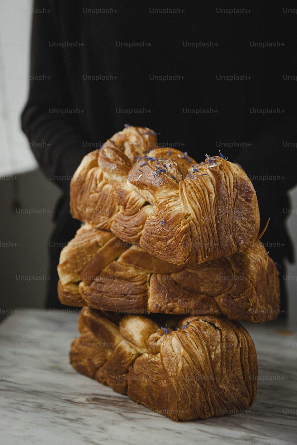 a stack of croissants sitting on top of a counter