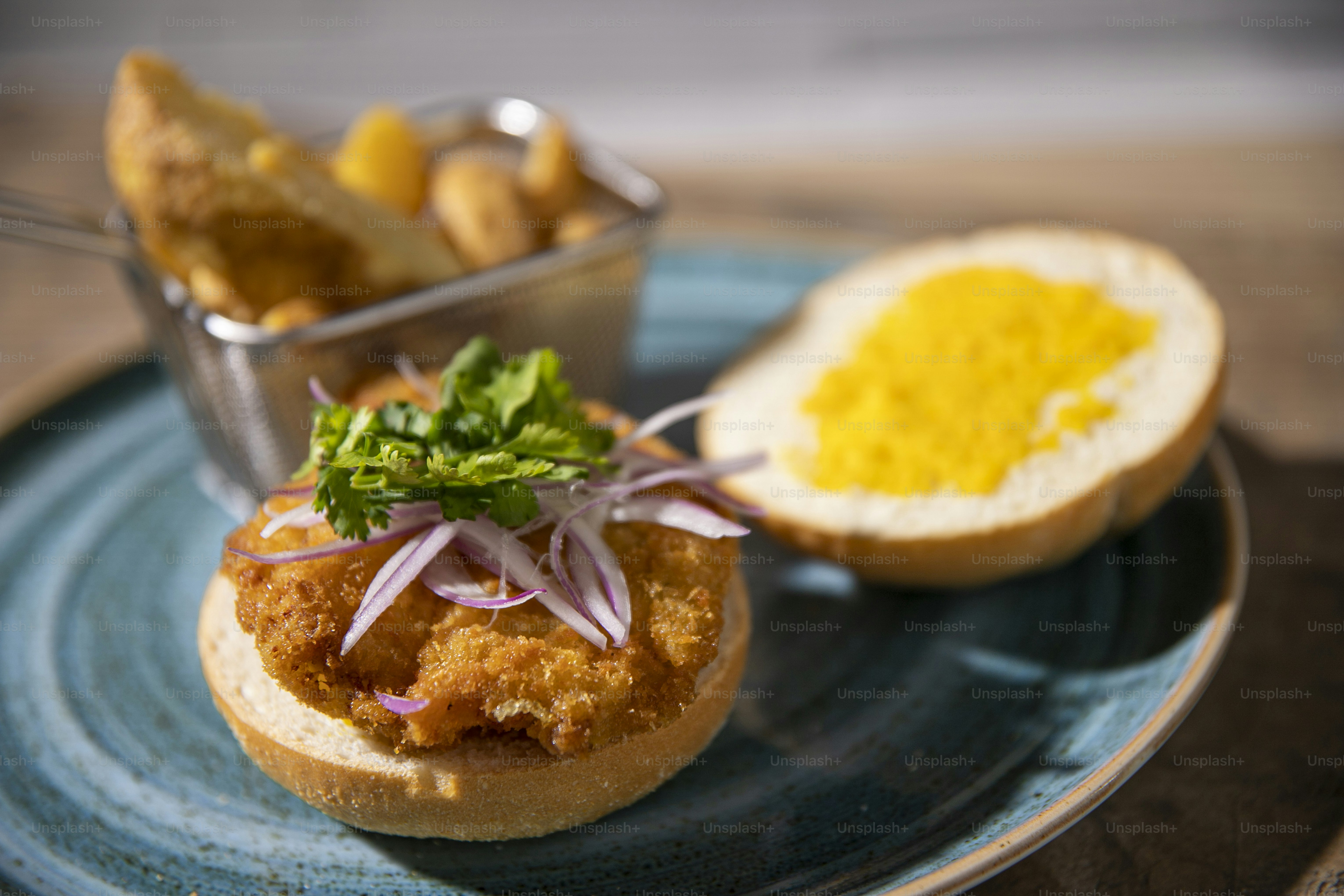 a plate with a sandwich and a bowl of mustard