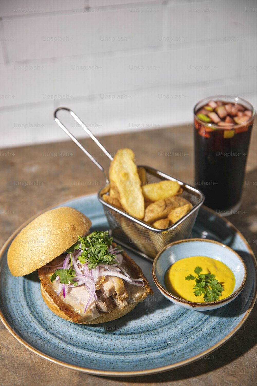 a blue plate topped with a sandwich and fries