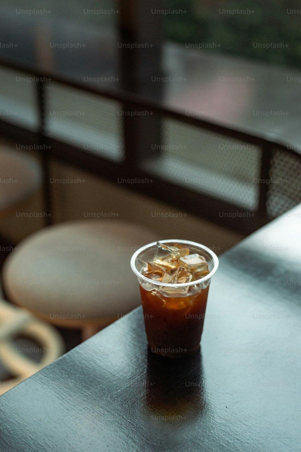 a plastic cup filled with ice sitting on top of a table