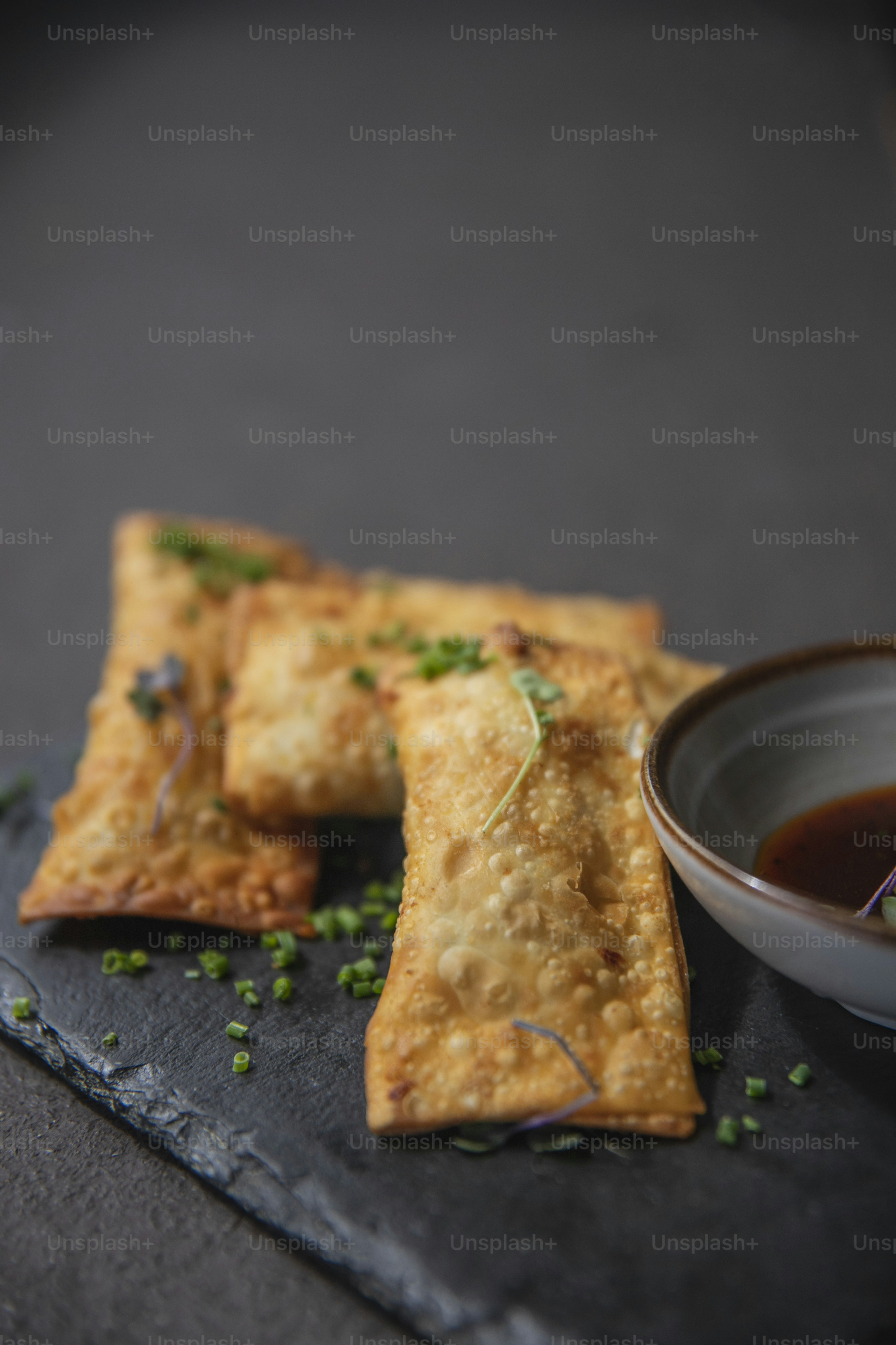 a plate of food with a bowl of dipping sauce