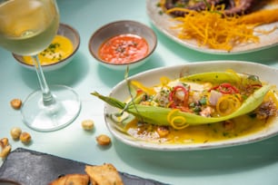 a table topped with plates of food and glasses of wine