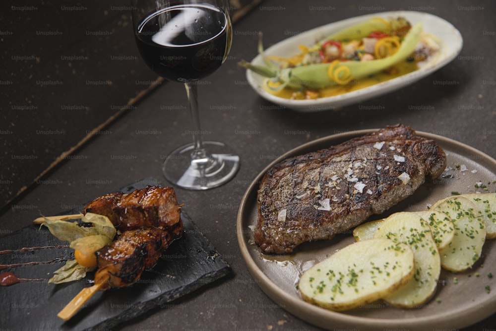 a plate of food and a glass of wine on a table