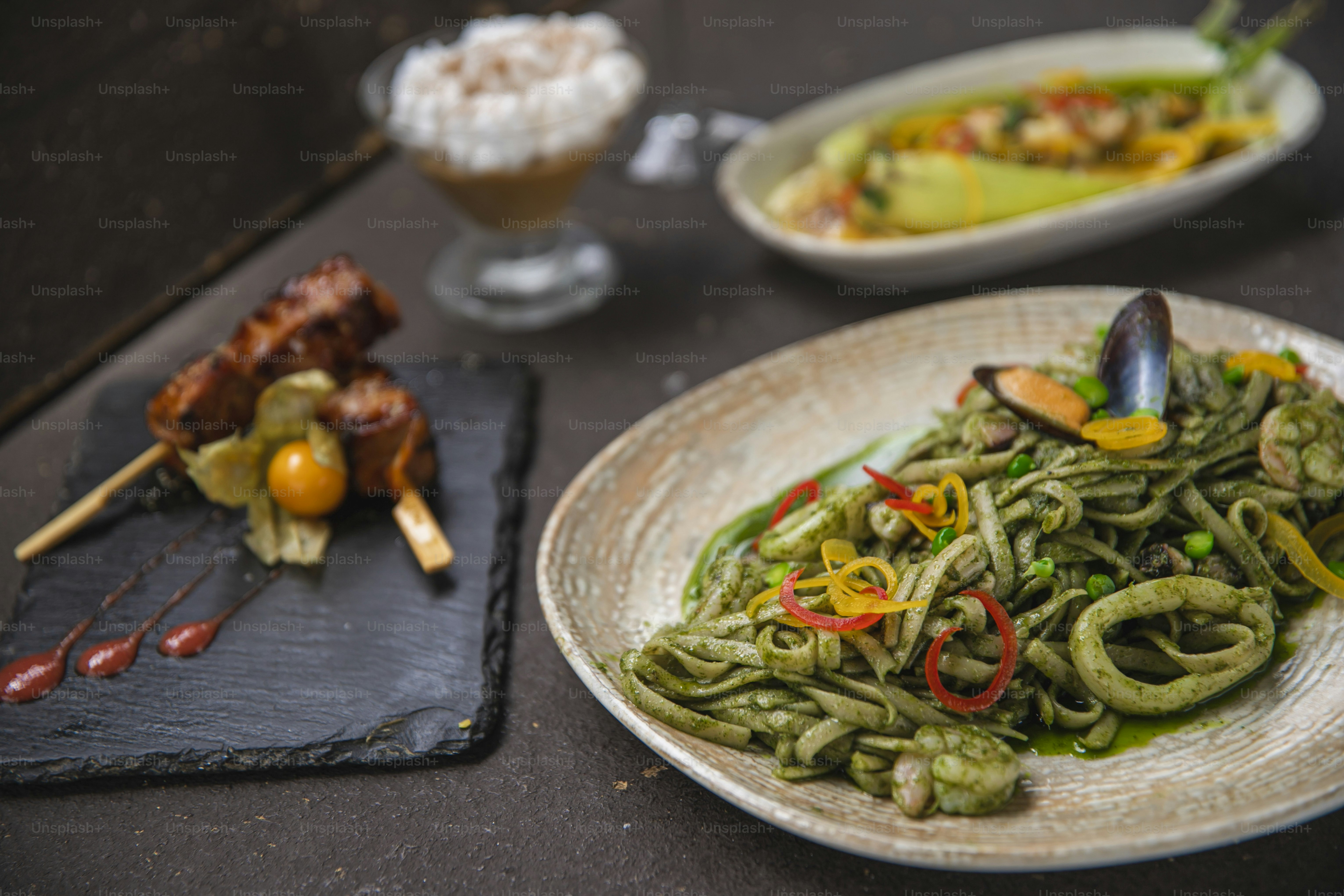 a plate of food on a table next to other plates of food