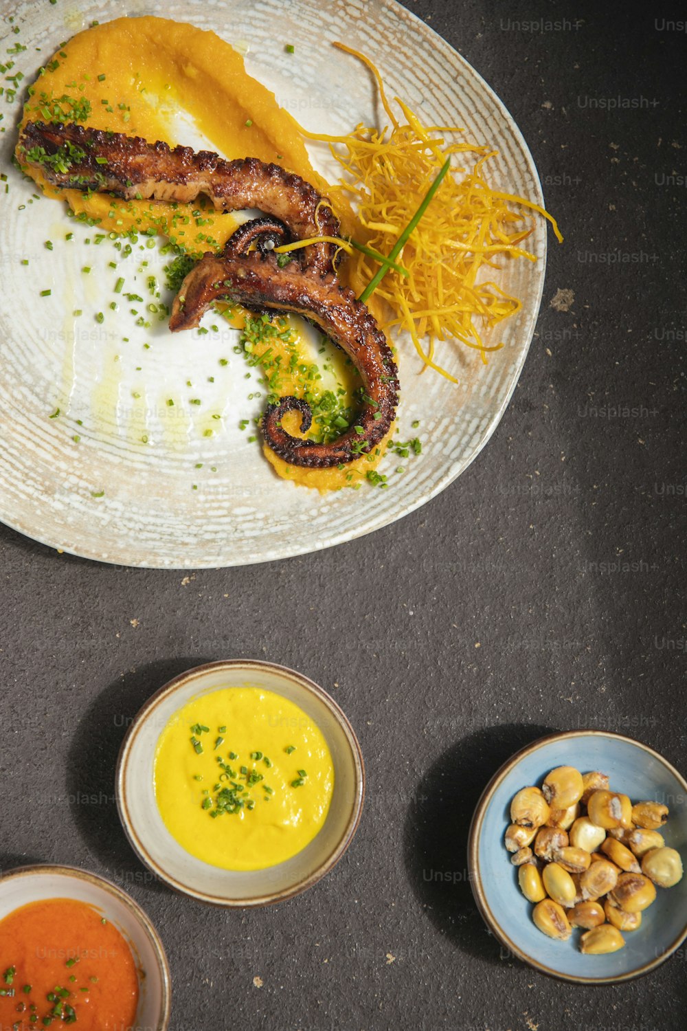 a plate of food on a table with sauces