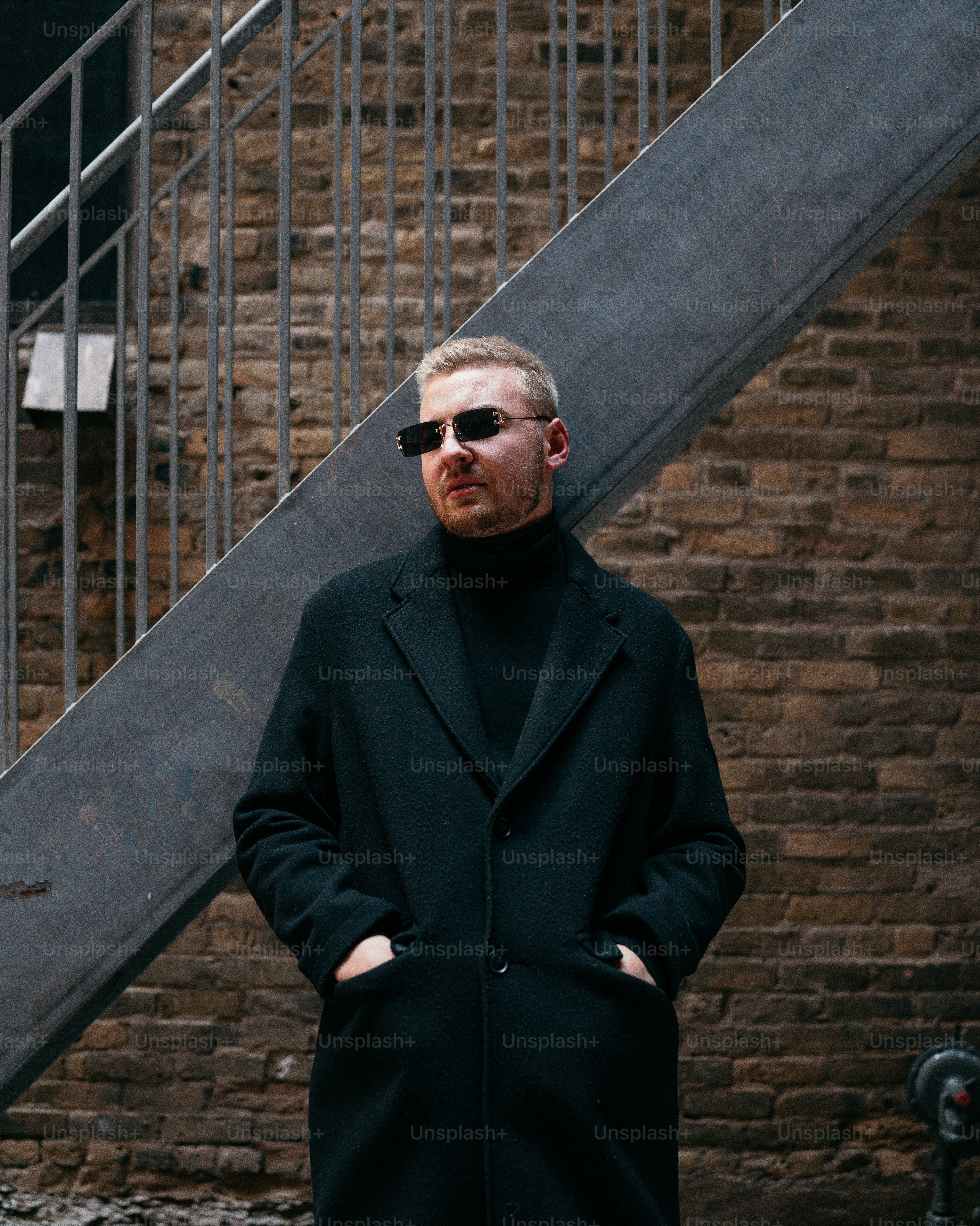 A man standing in front of a stair case photo – Style Image on Unsplash