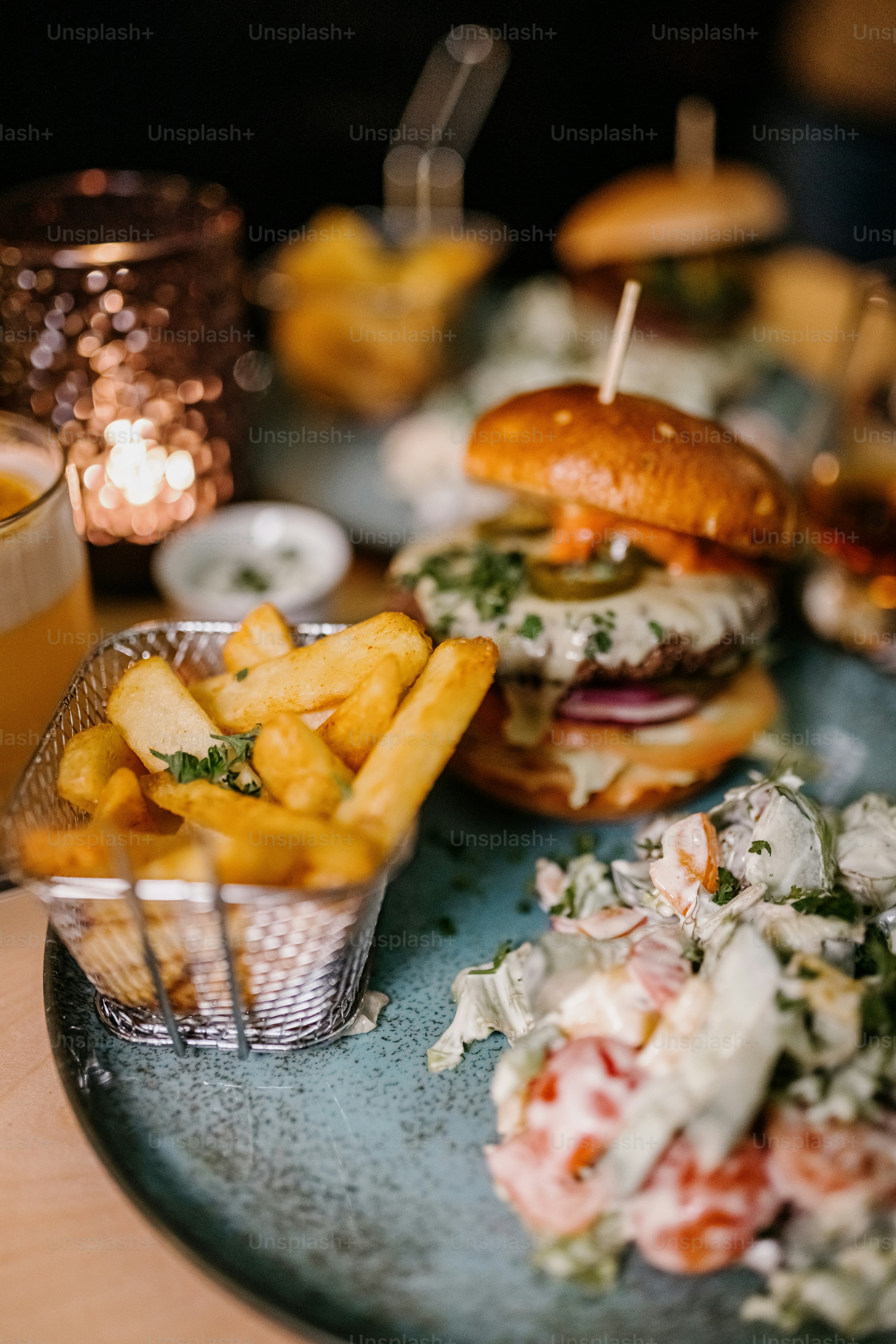 a blue plate topped with two burgers and french fries