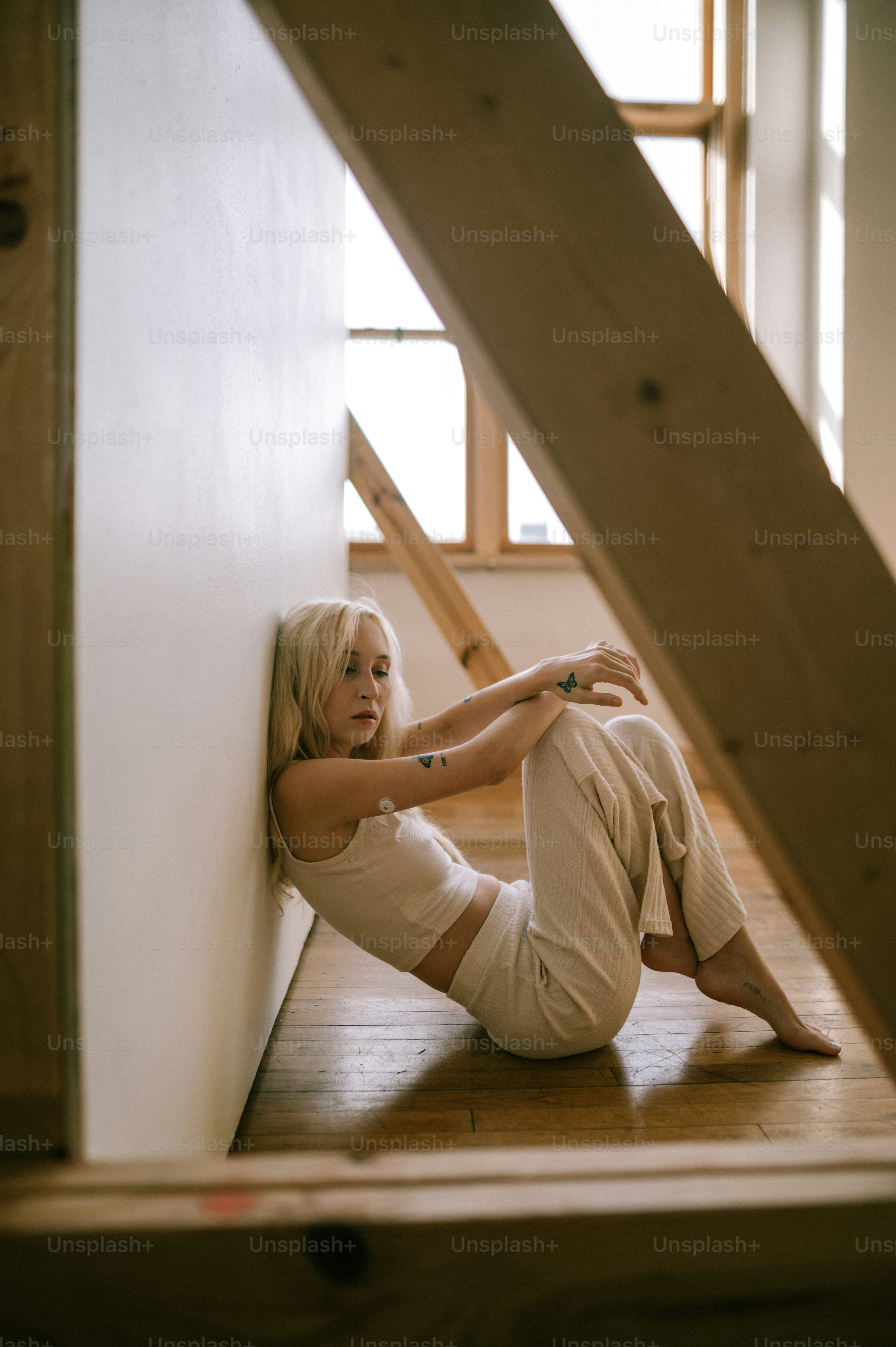 a woman sitting on the floor of a house