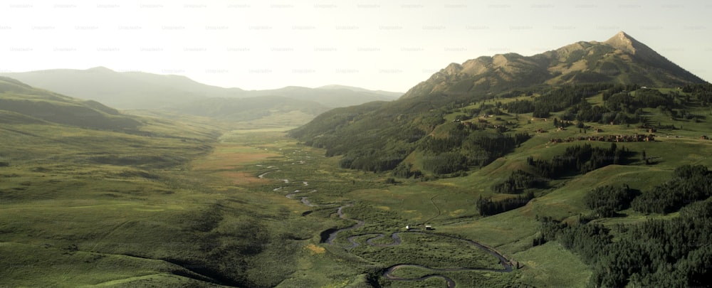 an aerial view of a winding road in the mountains