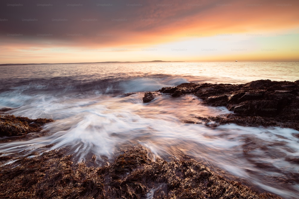 a large body of water near a rocky shore