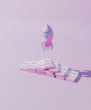 Un razzo giocattolo sta volando sopra una pila di blocchi rosa