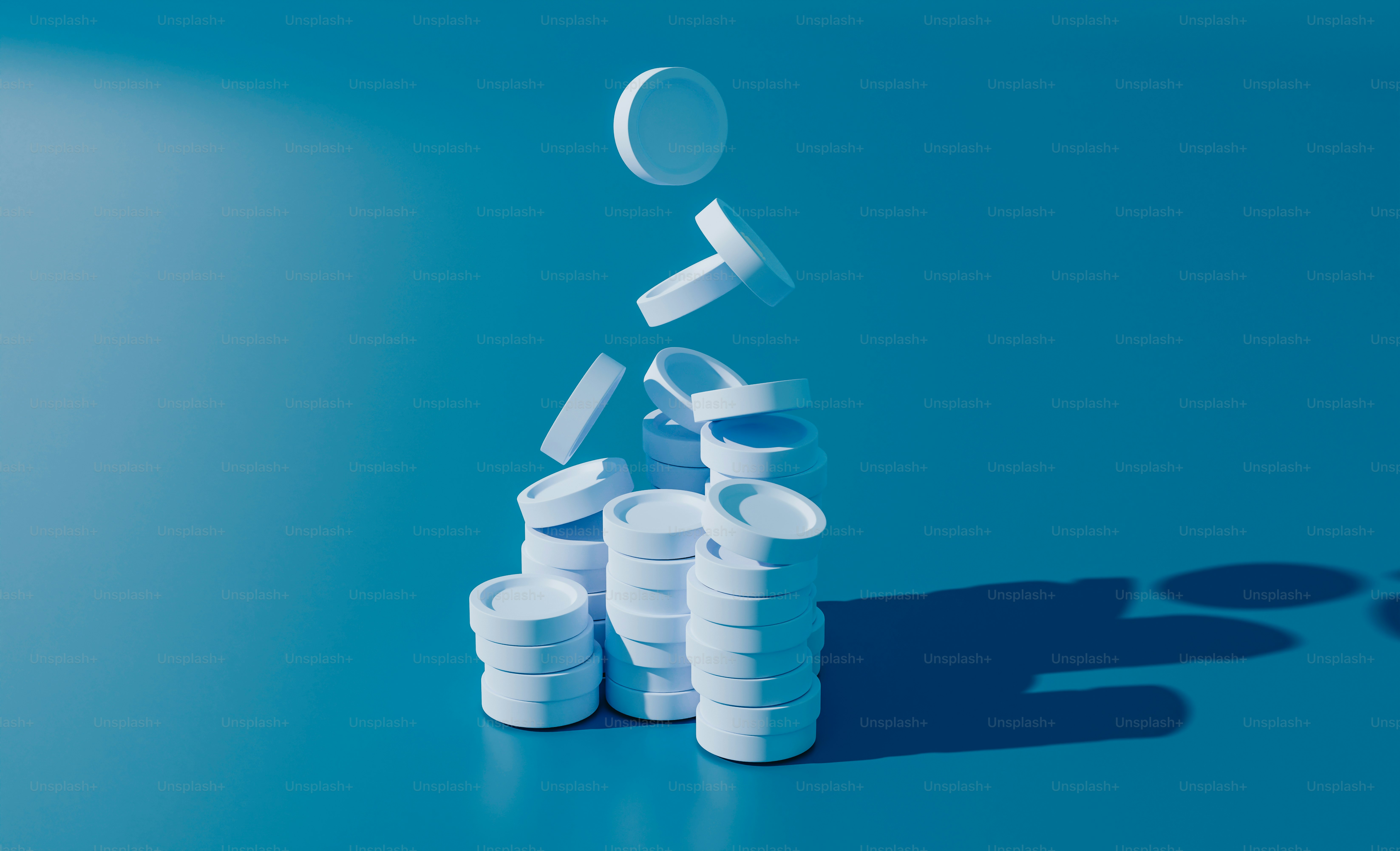 A stack of pills sitting on top of a blue table photo – Blue Image on ...