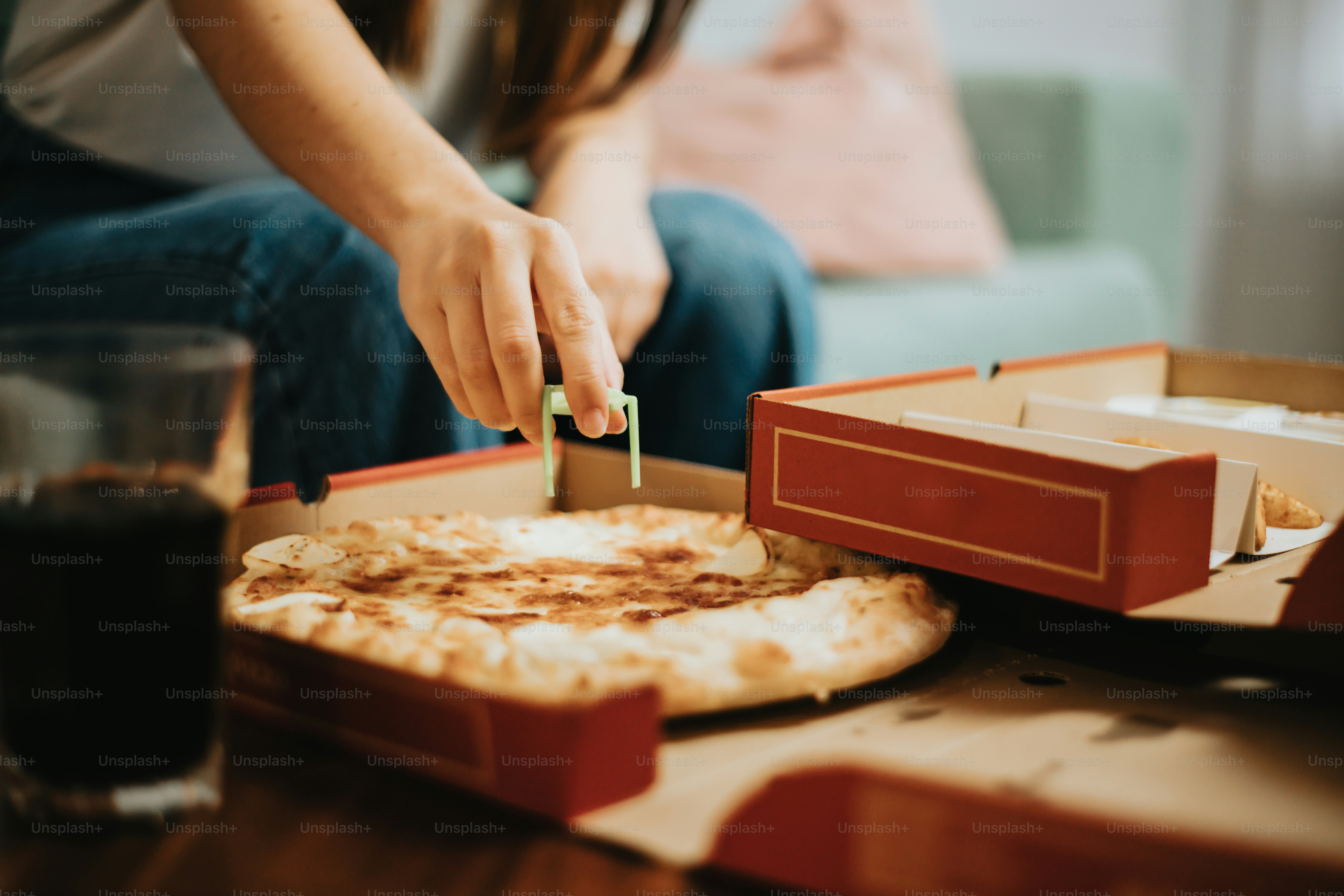 a person cutting a cake