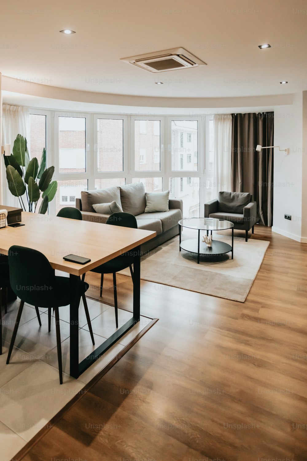 a living room filled with furniture and a large window